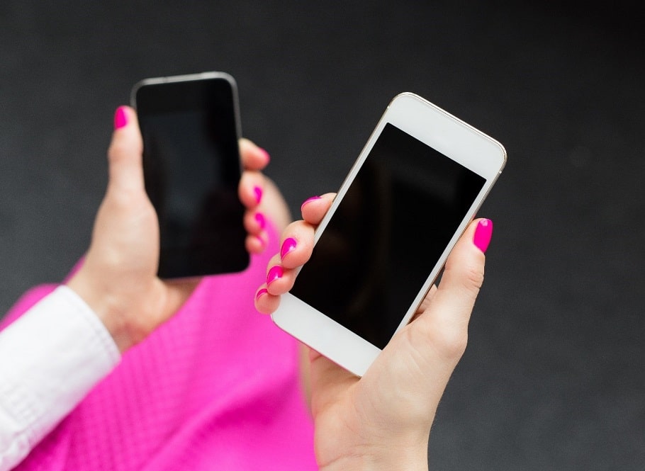 Womans hands holding two iPhones