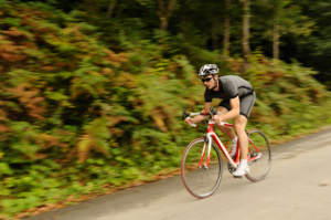 Road cyclist at downhill with blurred background