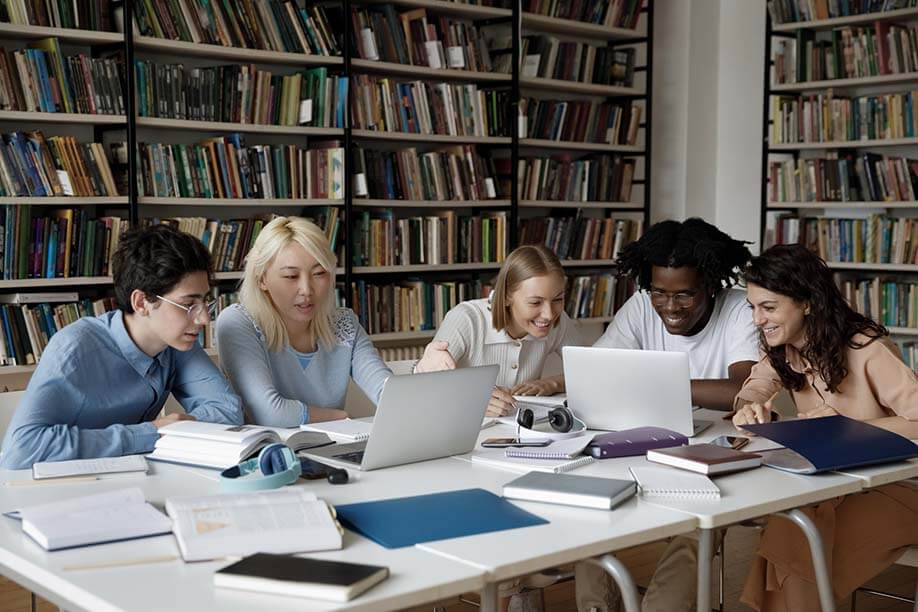 student friends at laptop around table