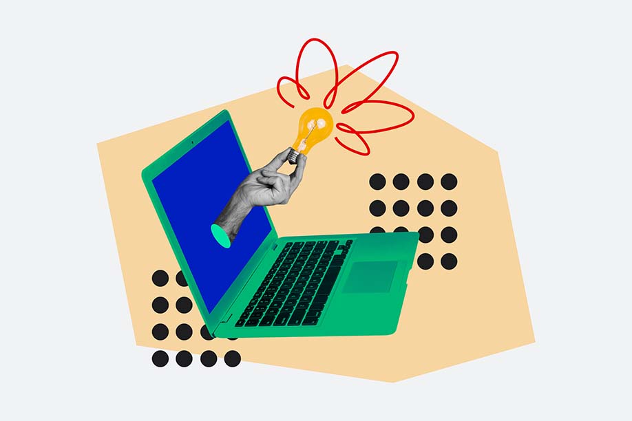 macbook with and hand holding a lightbulb